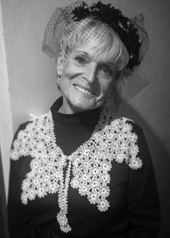 Black and white portrait of Vermont artist Veronica de Saint Phalle wearing an elaborate handcrafted tatted lace collar with floral and cascading motifs, demonstrating her mastery of traditional tatting techniques